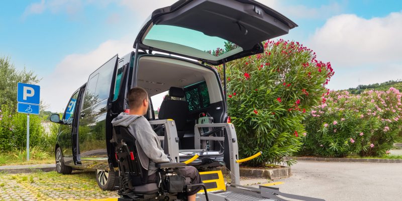 Accessible car with wheelchair lift ramp for person with disability